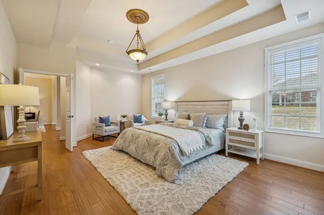 a bathroom with a double vanity sink a mirror a bathtub and shower