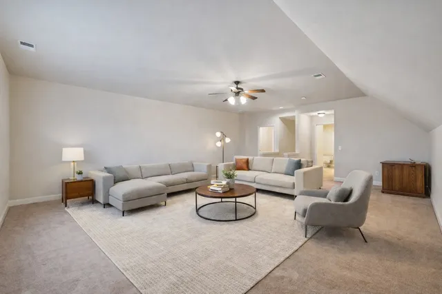 a view of a livingroom with a ceiling fan and window