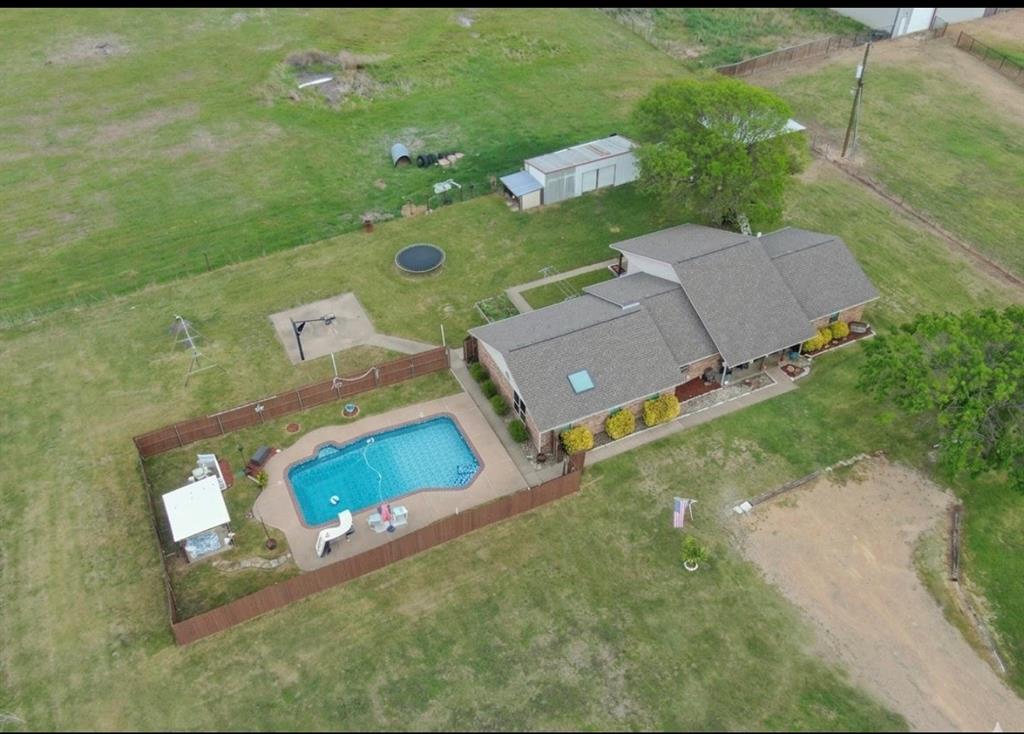 an aerial view of a house with a yard