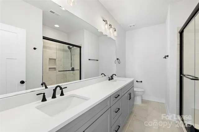 a bathroom with a double vanity sink mirror and double