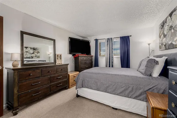 a bedroom with a bed and a flat screen television