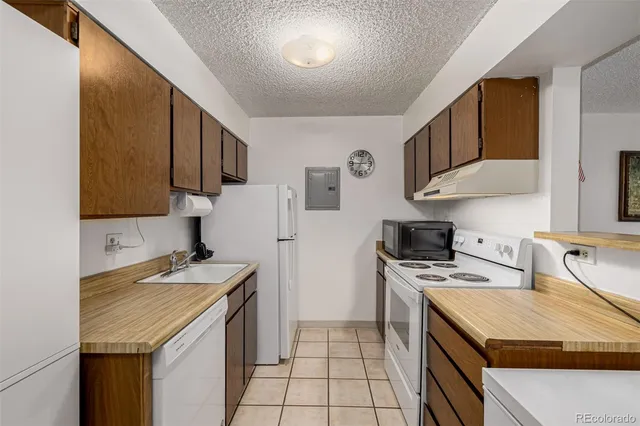 a kitchen with a sink a stove and a refrigerator