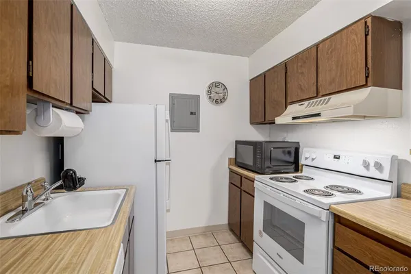 a kitchen with a sink a stove and refrigerator