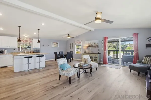 a living room with furniture and kitchen view