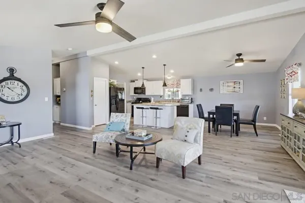 a kitchen with kitchen island granite countertop a sink and refrigerator