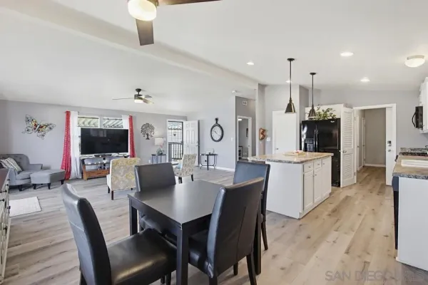a kitchen with stainless steel appliances granite countertop a sink a stove and refrigerator