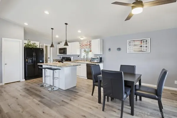 a kitchen with a stove and a wooden floor