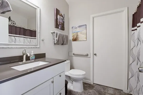 a view of washer and dryer with kitchen in the background