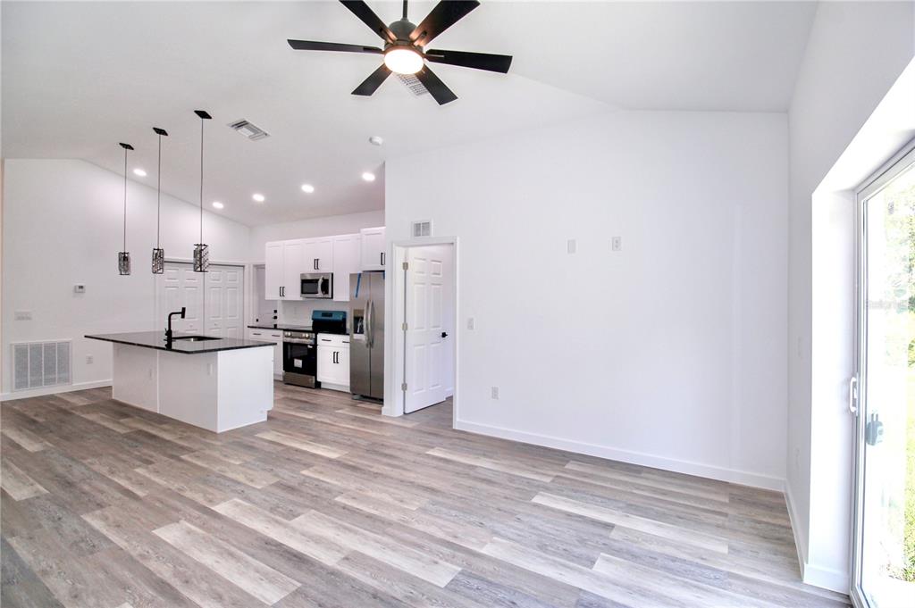 454 Bonnie Road Northwest Lake Placid, FL 33852 - Photo 14 of 30 a view of kitchen with stainless steel appliances kitchen island white cabinets and wooden floor