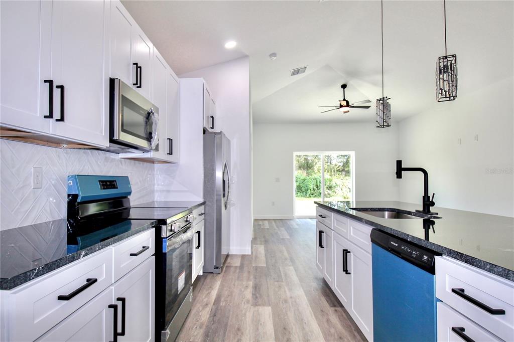 454 Bonnie Road Northwest Lake Placid, FL 33852 - Photo 9 of 30 a kitchen with stainless steel appliances a sink dishwasher a stove and a refrigerator