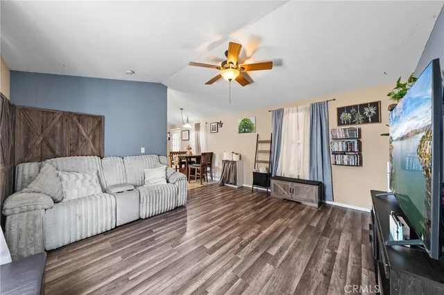 a living room with furniture a flat screen tv and a table