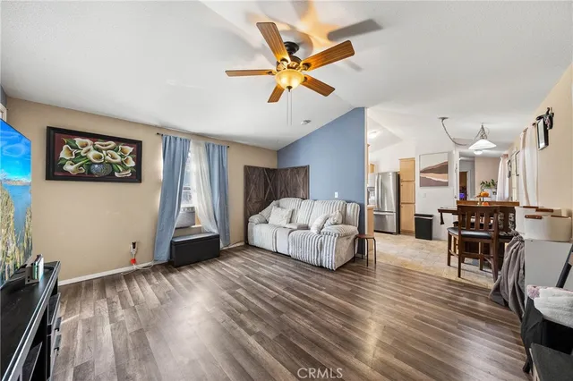 a living room with furniture and a ceiling fan