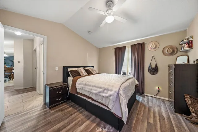 a bedroom with a bed and a flat tv screen on dresser