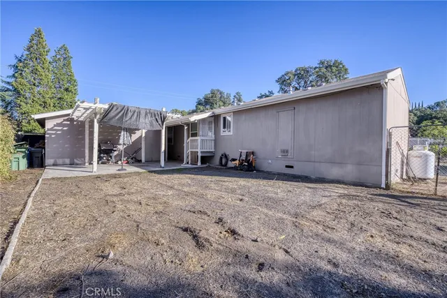 a view of a porch with furniture and a yard