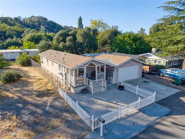 an aerial view of a house with swimming pool and furniture