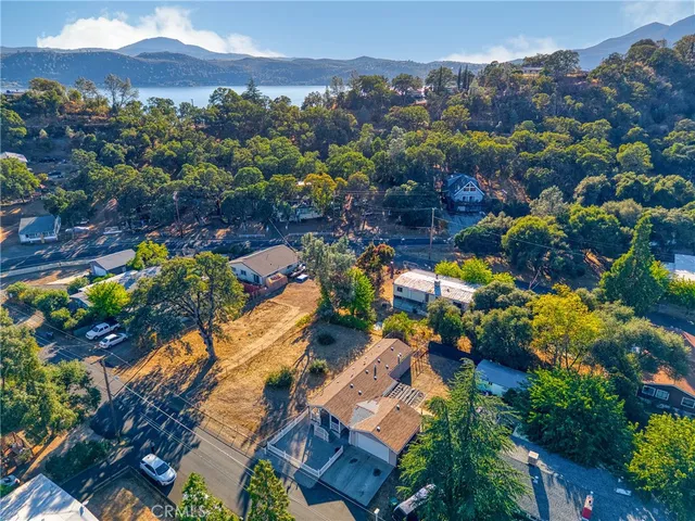 an aerial view of a house with a lot of trees