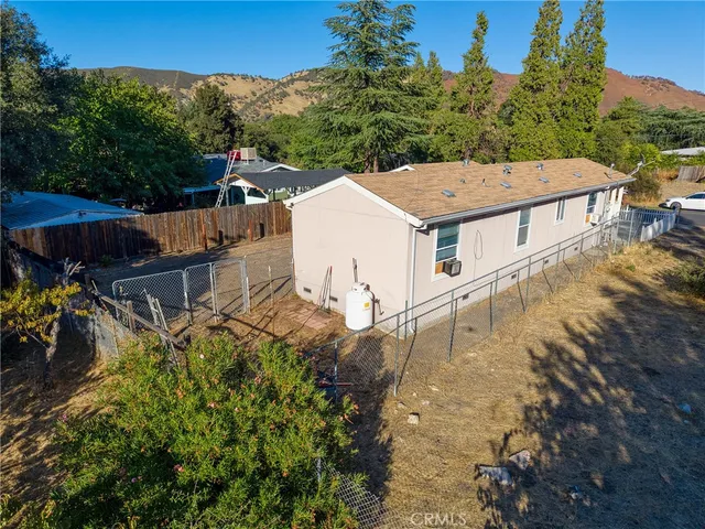 an aerial view of a houses with yard