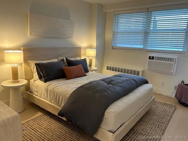 a bedroom with a bed and window