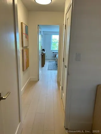 a view of a hallway with wooden floor
