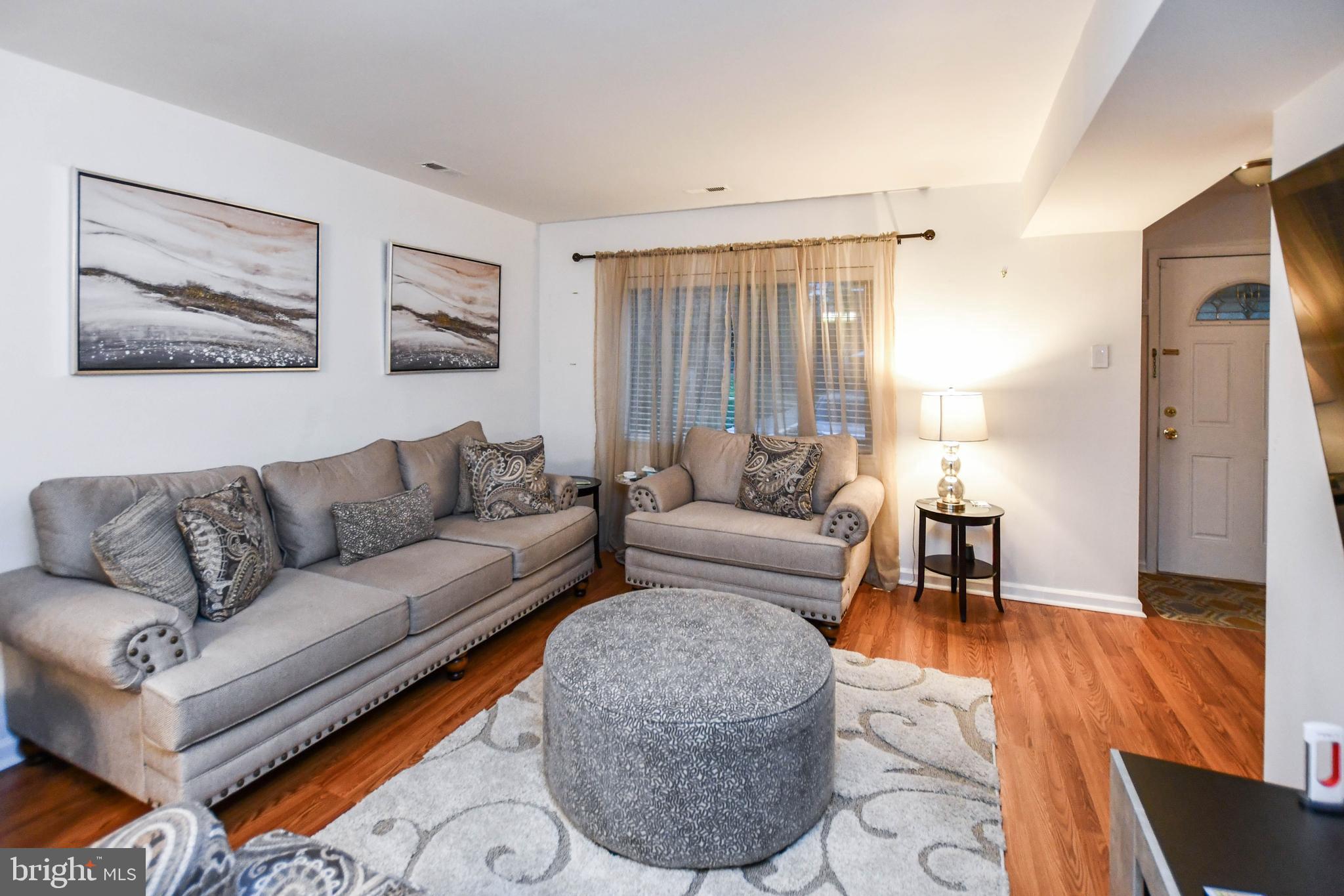 8317 Canning Terrace Greenbelt, MD 20770 - Photo 1 of 50 a living room with furniture and a window