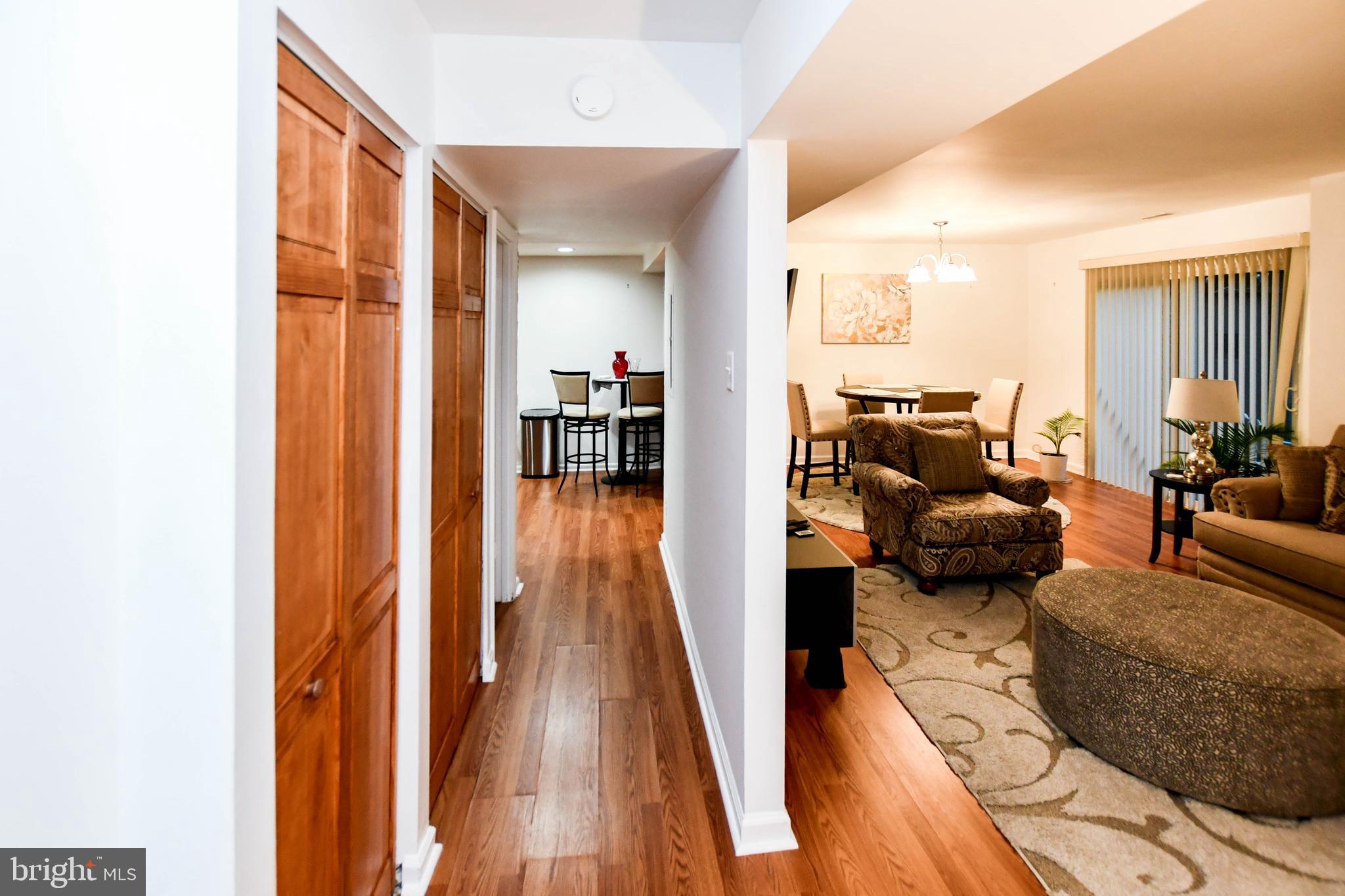 8317 Canning Terrace Greenbelt, MD 20770 - Photo 2 of 50 a living room with furniture floor to ceiling window and wooden floor