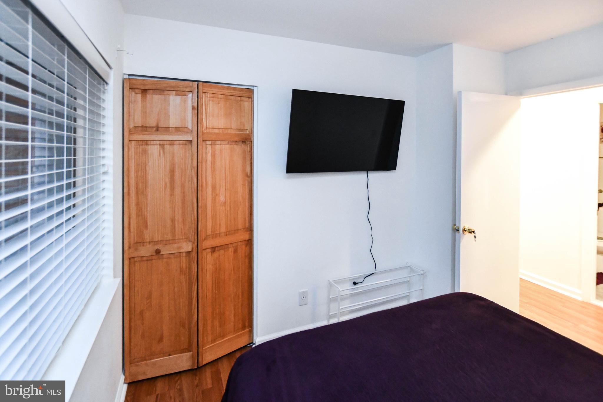 8317 Canning Terrace Greenbelt, MD 20770 - Photo 22 of 50 a living room with a flat screen tv