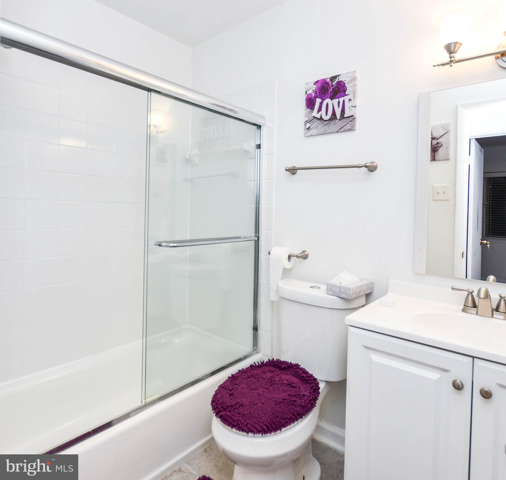8317 Canning Terrace Greenbelt, MD 20770 - Photo 24 of 50 a bathroom with a sink toilet and shower