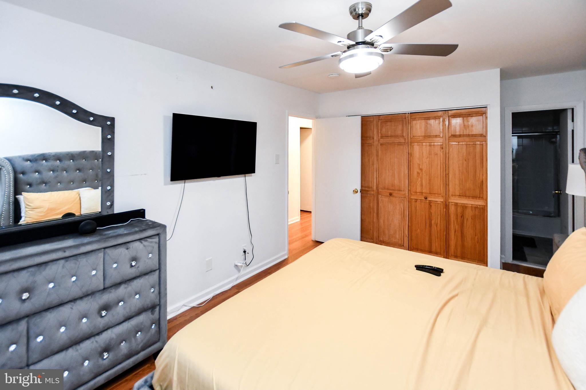 8317 Canning Terrace Greenbelt, MD 20770 - Photo 28 of 50 a bedroom with a bed and a flat screen tv