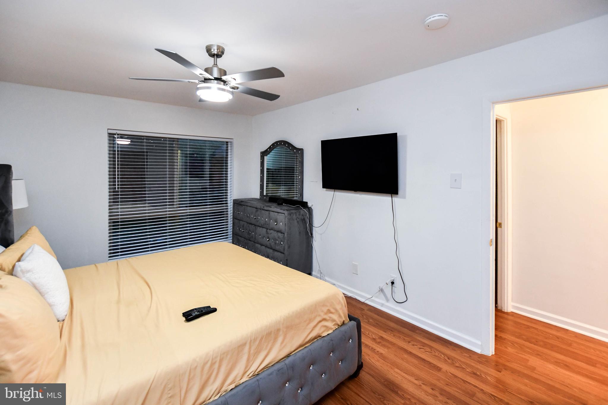 8317 Canning Terrace Greenbelt, MD 20770 - Photo 29 of 50 a bedroom with a bed and a flat screen tv