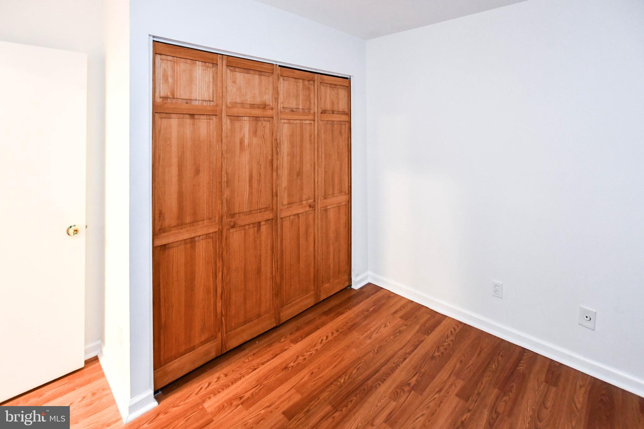 8317 Canning Terrace Greenbelt, MD 20770 - Photo 34 of 50 a view of an empty room with wooden floor