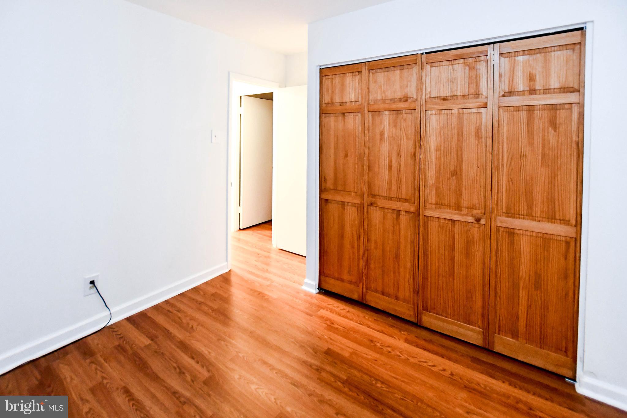 8317 Canning Terrace Greenbelt, MD 20770 - Photo 35 of 50 an empty room with wooden floor