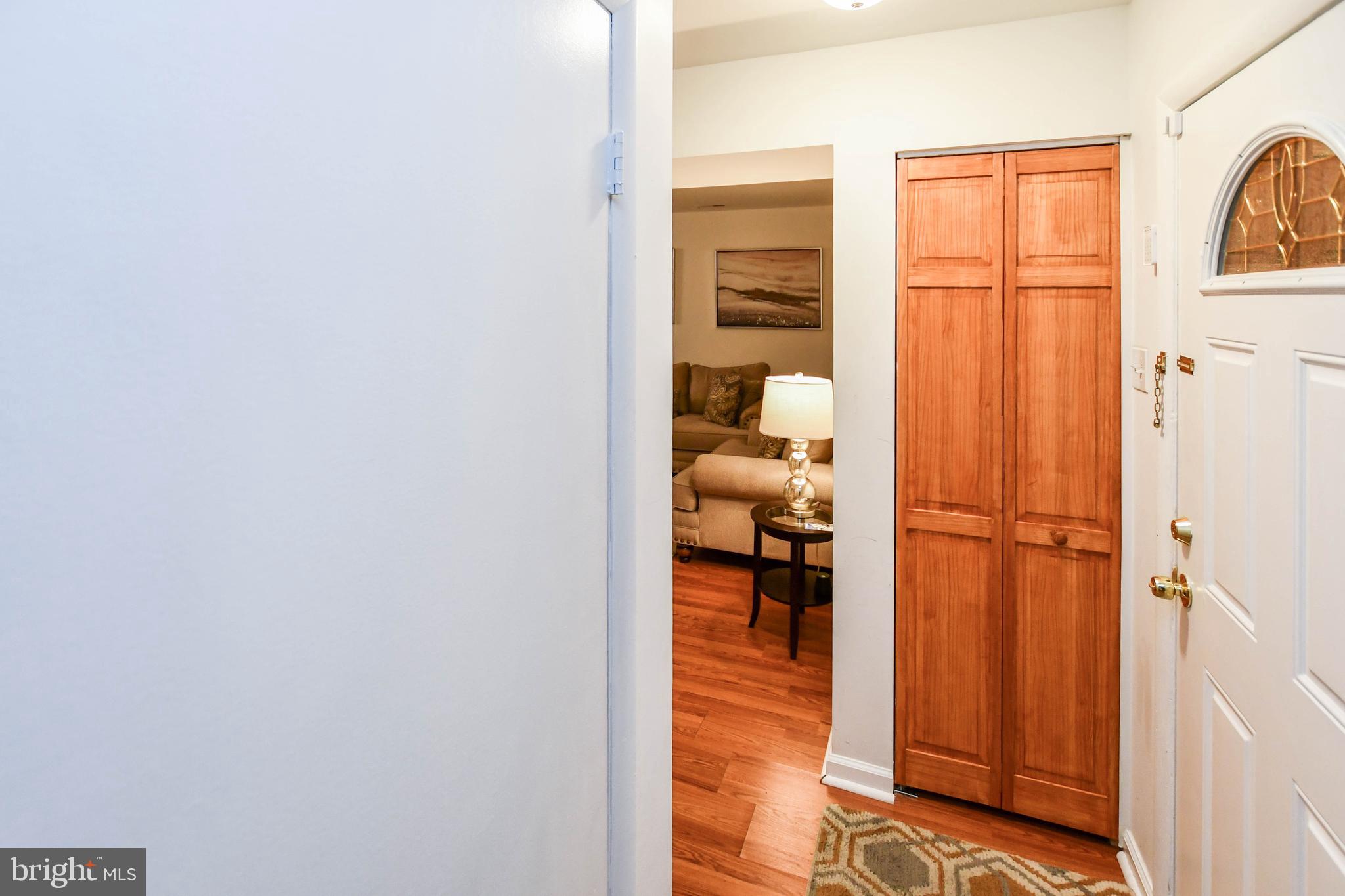 8317 Canning Terrace Greenbelt, MD 20770 - Photo 37 of 50 a view of a hallway with wooden floor and a bathroom