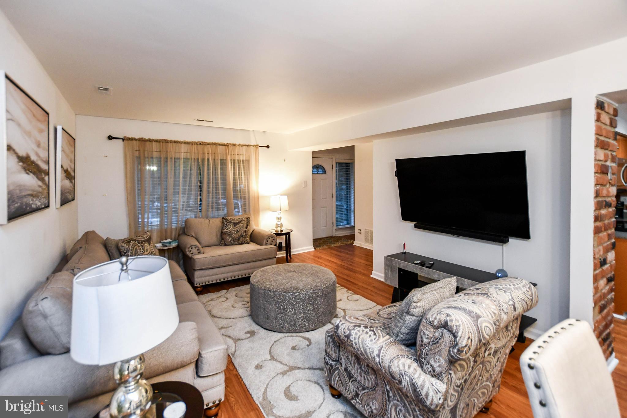 8317 Canning Terrace Greenbelt, MD 20770 - Photo 4 of 50 a living room with furniture and a flat screen tv