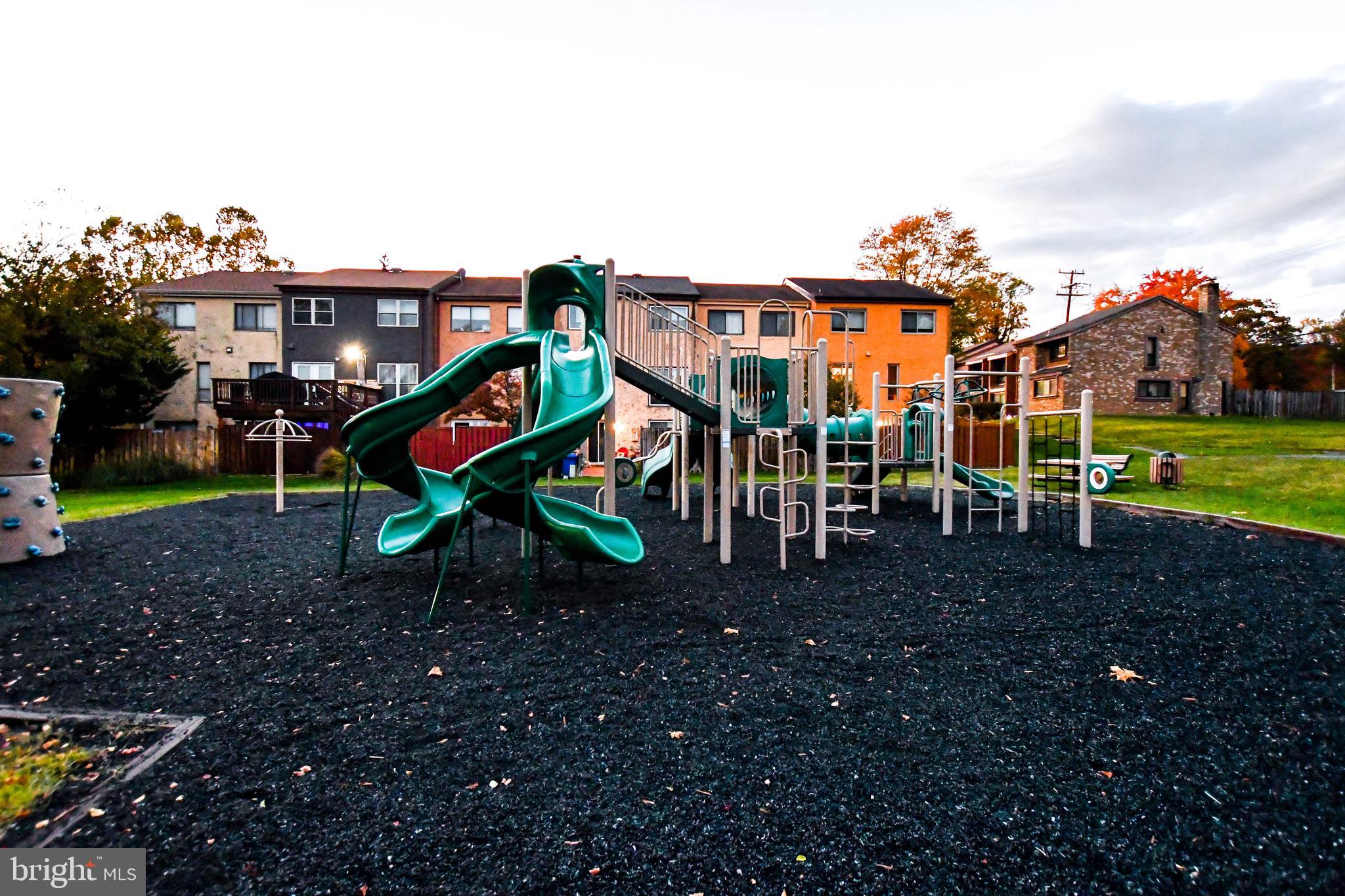 8317 Canning Terrace Greenbelt, MD 20770 - Photo 42 of 50 a view of a park with swings and slides