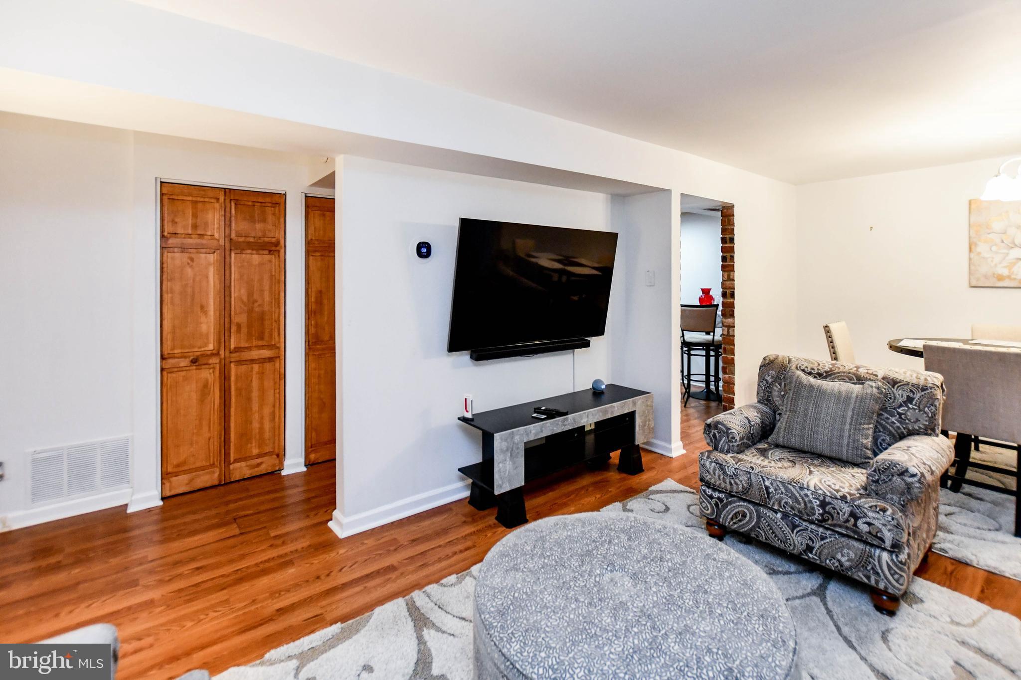 8317 Canning Terrace Greenbelt, MD 20770 - Photo 5 of 50 a living room with furniture and a flat screen tv