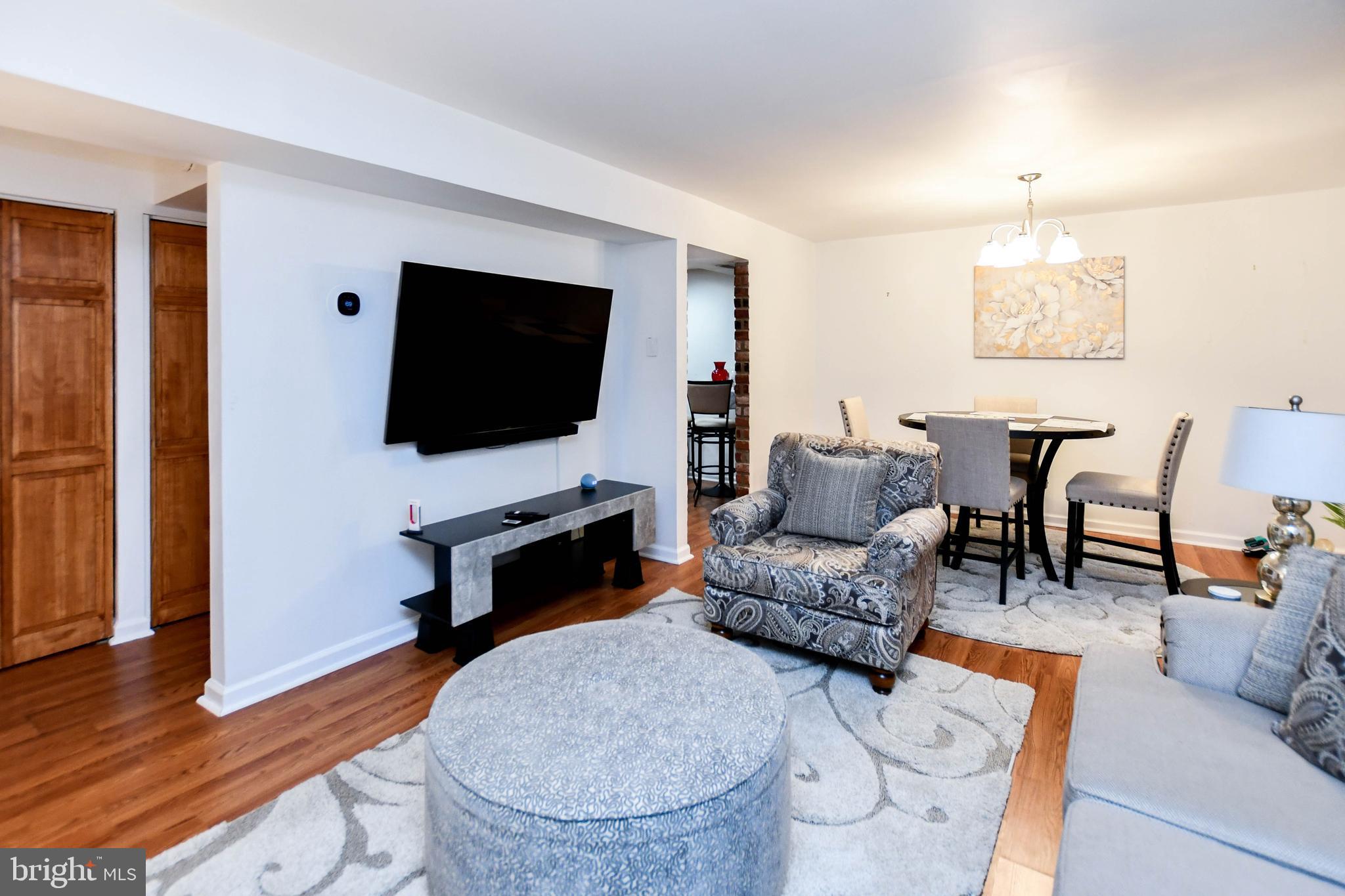 8317 Canning Terrace Greenbelt, MD 20770 - Photo 6 of 50 a living room with furniture and a flat screen tv