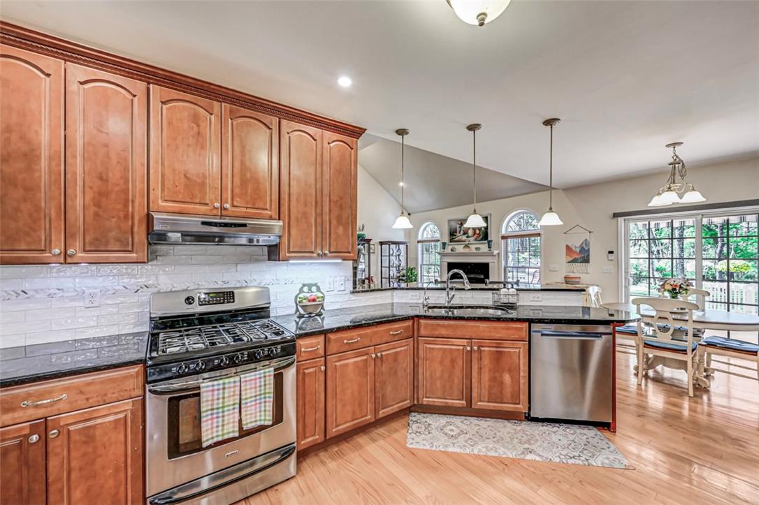 112 Michaels Run Road Stroudsburg, PA 18360 - Photo 25 of 69 The Kitchen has a propane stove with beautiful granite countertops and a tile backsplash.