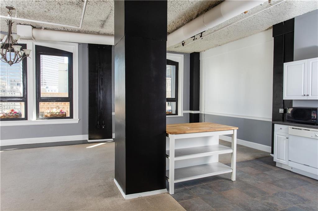 Open kitchen opening into brightly lit living room with spectacular views