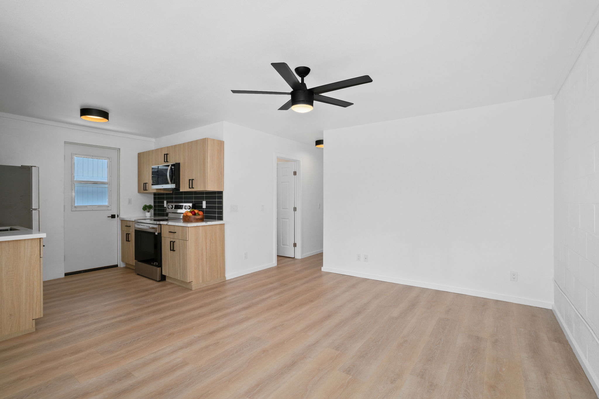 4484 Panako Road Waimea, HI 96796 - Photo 16 of 27 a kitchen with a refrigerator and white cabinets