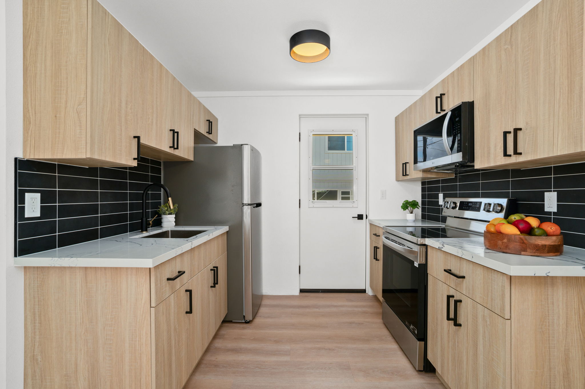4484 Panako Road Waimea, HI 96796 - Photo 17 of 27 a kitchen with stainless steel appliances granite countertop a stove and a refrigerator