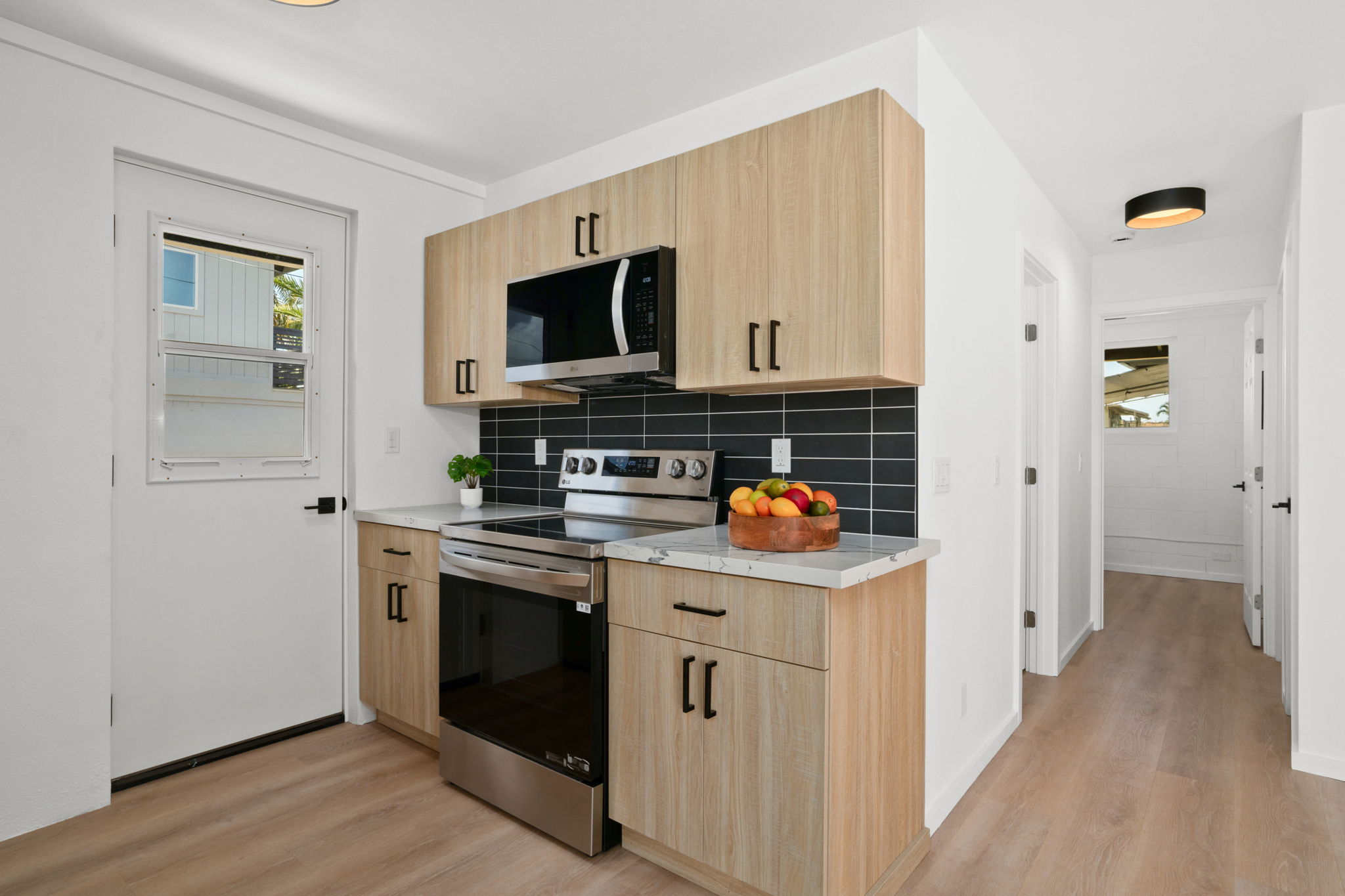 4484 Panako Road Waimea, HI 96796 - Photo 18 of 27 a kitchen with stainless steel appliances a stove microwave and refrigerator