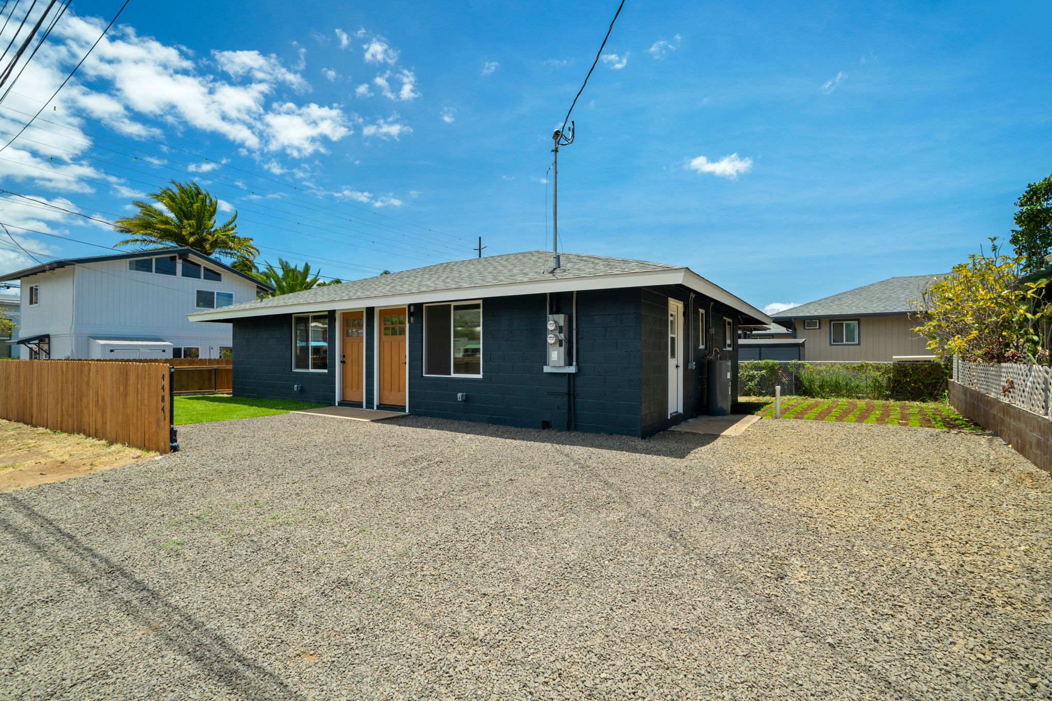 4484 Panako Road Waimea, HI 96796 - Photo 2 of 27 a front view of a house with a yard and garage