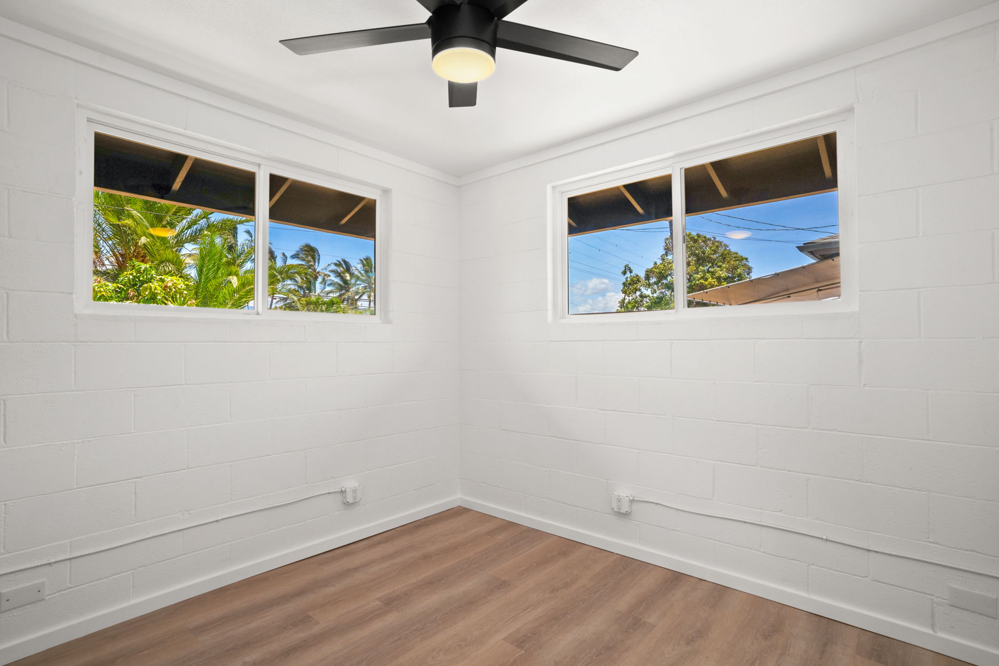 4484 Panako Road Waimea, HI 96796 - Photo 24 of 27 en empty room with wooden floor and ceiling fan