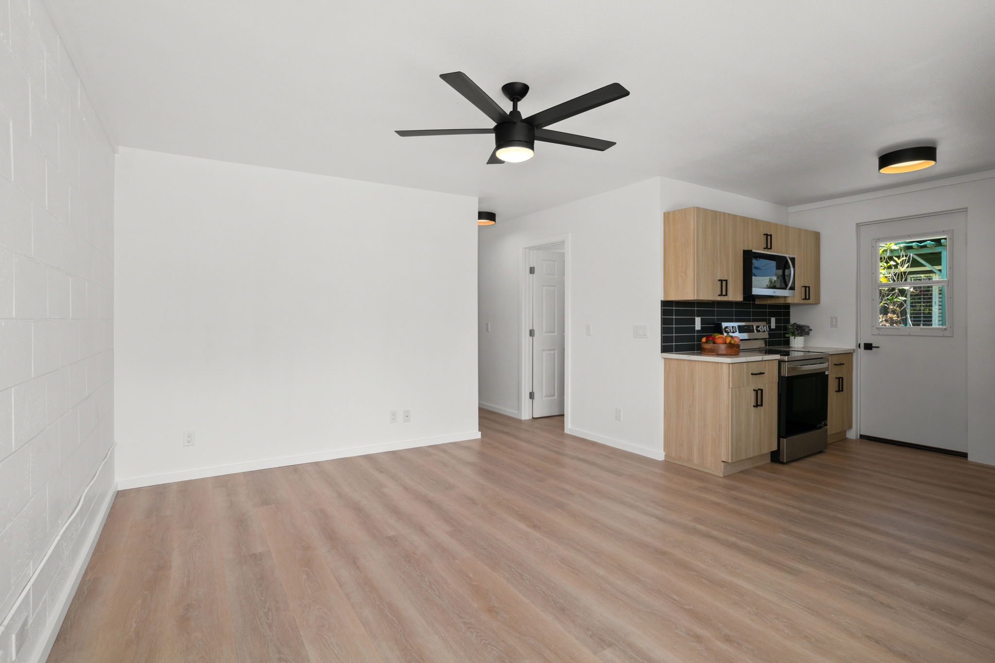 4484 Panako Road Waimea, HI 96796 - Photo 7 of 27 a view of a kitchen with wooden floor and stainless steel appliances
