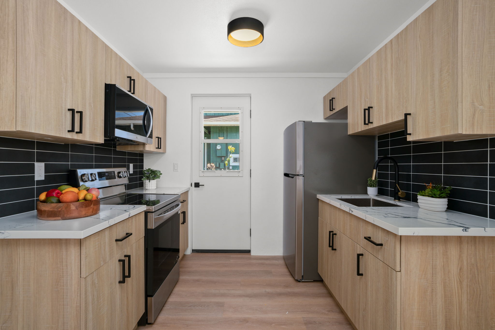 4484 Panako Road Waimea, HI 96796 - Photo 8 of 27 a kitchen with stainless steel appliances granite countertop a stove and a refrigerator