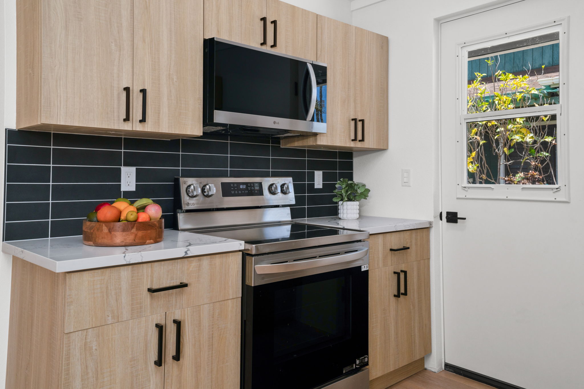 4484 Panako Road Waimea, HI 96796 - Photo 9 of 27 a kitchen with stainless steel appliances granite countertop a stove and a microwave