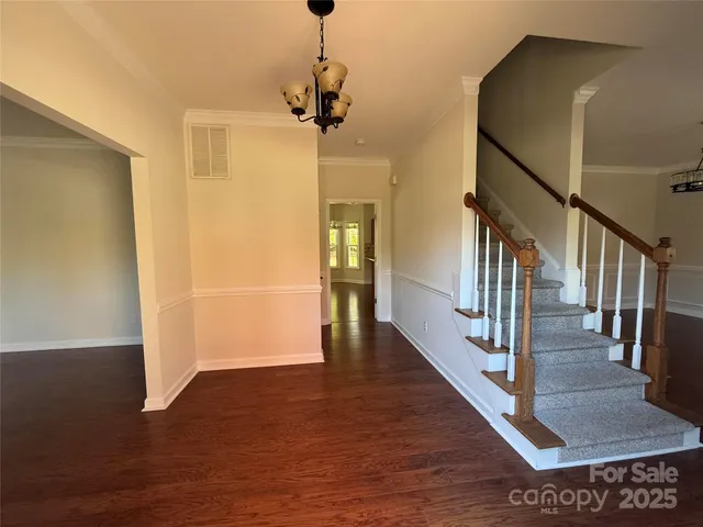 a view interior of a house with wooden floor stairs and a chandelier