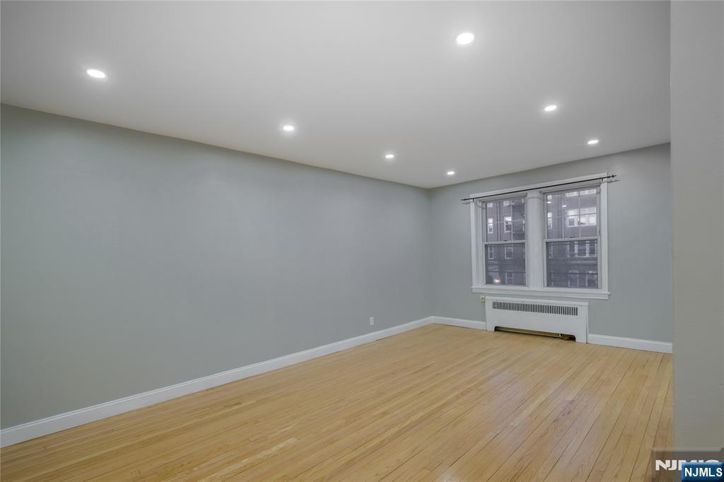 155 Union Avenue, Unit 201 Rutherford, NJ 07070 - Photo 4 of 15 a view of empty room with wooden floor and fan
