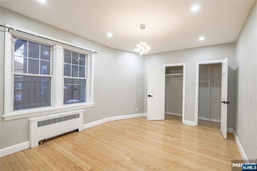 155 Union Avenue, Unit 201 Rutherford, NJ 07070 - Photo 7 of 15 a view of empty room with wooden floor and fan