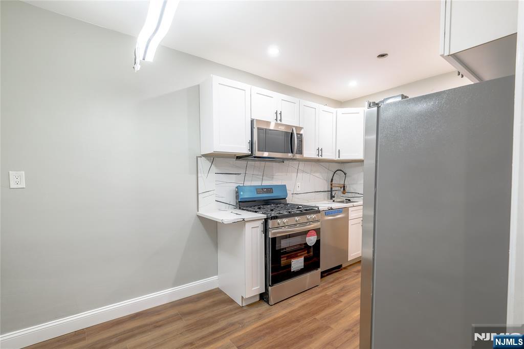 155 Union Avenue, Unit 201 Rutherford, NJ 07070 - Photo 10 of 15 a kitchen with stainless steel appliances granite countertop a stove and a refrigerator